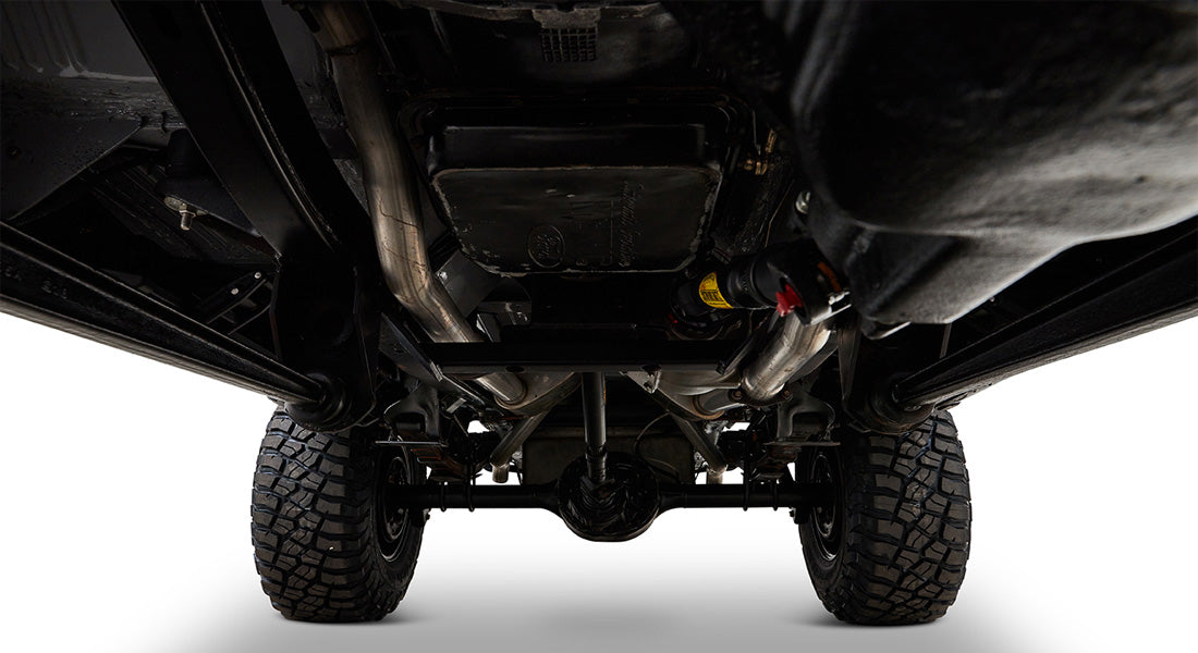 Undercarriage of Classic Ford Bronco showing rear differential, suspension, and tires