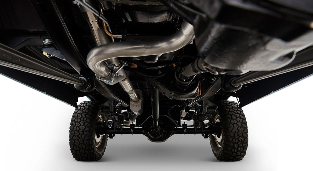 Undercarriage view showing suspension, exhaust, and tires of Classic Ford Bronco