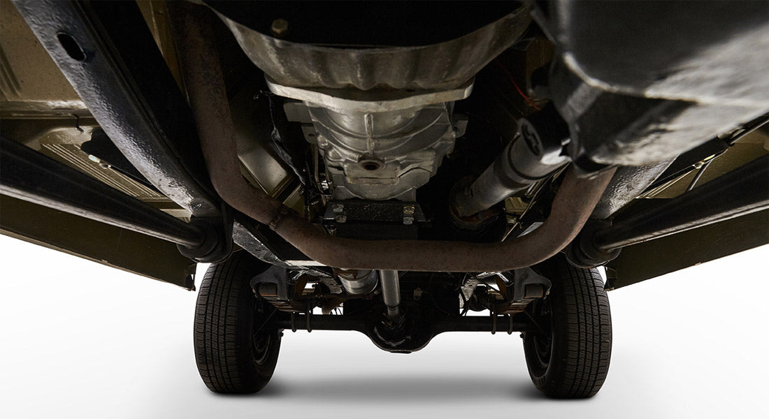 Undercarriage view of Classic Ford Bronco showing exhaust system, rear axle, and tires
