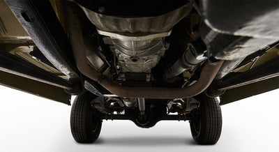 Undercarriage view of Classic Ford Bronco showing exhaust system, rear axle, and tires