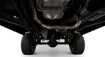 Undercarriage of Classic Ford Bronco displaying exhaust pipes, differential, and tires