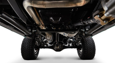 Undercarriage view showing exhaust pipes, suspension components, and tires against white background