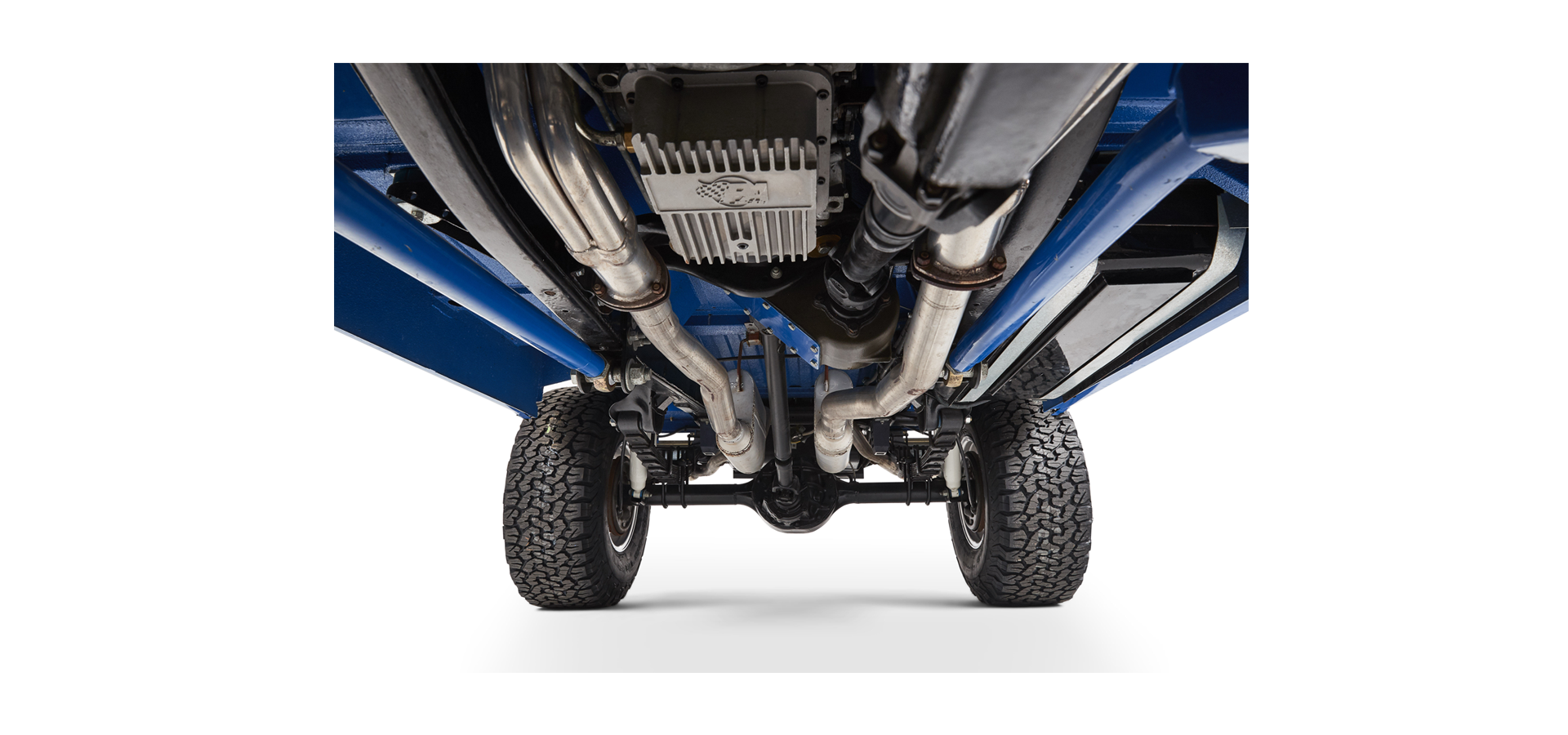 Undercarriage close-up of Classic Ford Bronco showing exhaust pipes and rear differential