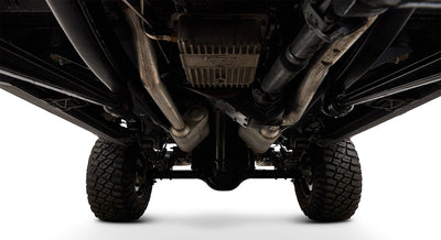 Undercarriage of Classic Ford Bronco showing axles, exhaust, and tires from below