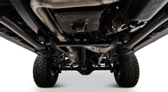 Undercarriage view showing suspension, exhaust pipes, and tires of Classic Ford Bronco