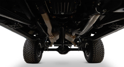 Undercarriage view of Classic Ford Bronco showing exhaust pipes, rear differential, and suspension.