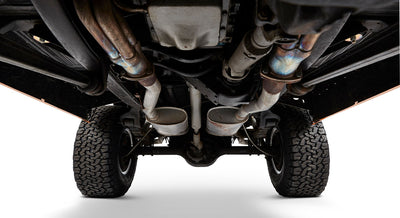 Undercarriage view showing exhaust system and rear tires of Classic Ford Bronco
