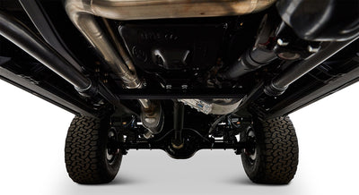 View of Classic Ford Bronco undercarriage showing exhaust pipes, driveshaft, and suspension