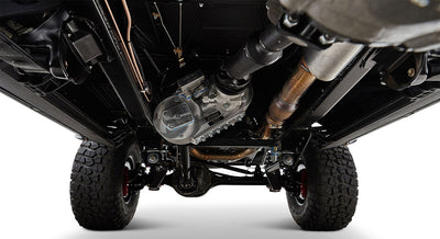 Undercarriage view of Classic Ford Bronco showing drive shaft, exhaust pipes, and suspension components