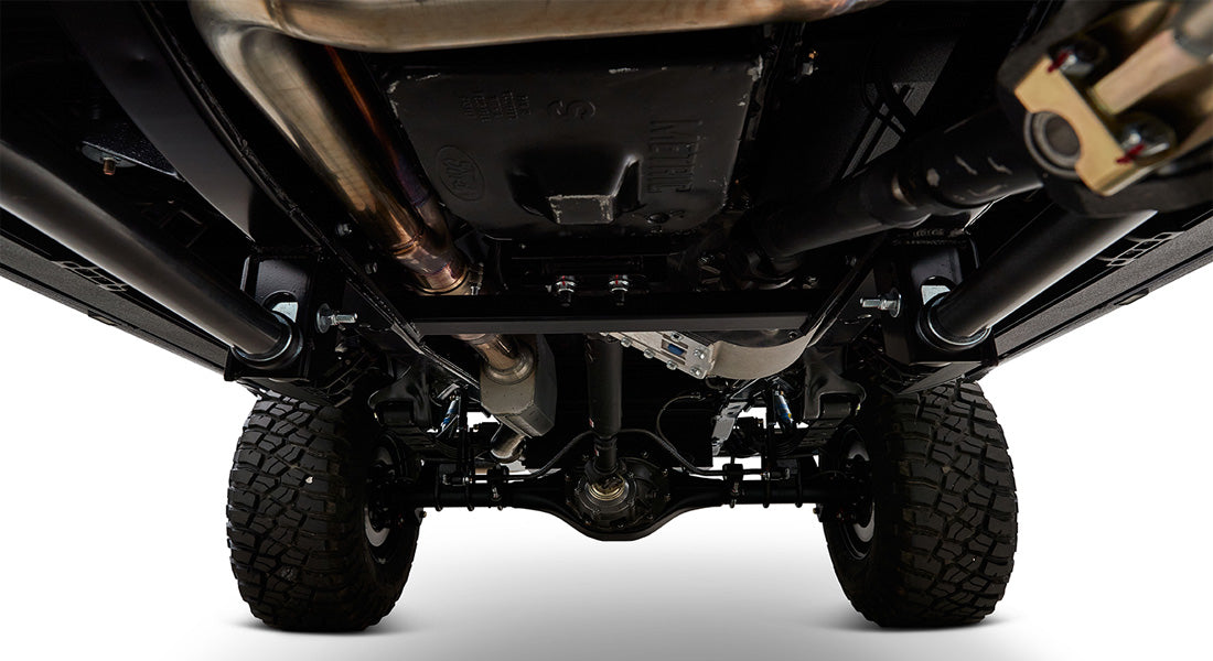 Undercarriage view of a Classic Ford Bronco showing suspension and exhaust components