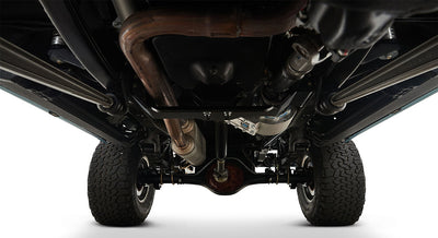 Undercarriage view showing suspension, exhaust, and tires of a Classic Ford Bronco