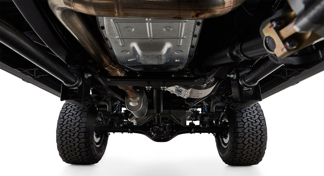 Undercarriage view showing suspension, exhaust system, differential, and tires of Classic Ford Bronco