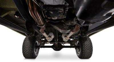 Detailed undercarriage view of Classic Ford Bronco with dual exhaust pipes and rear end components.