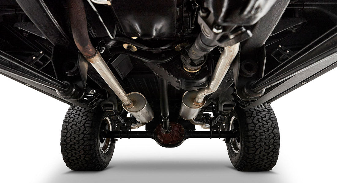 Undercarriage with dual exhaust system and suspension visible under Classic Ford Bronco