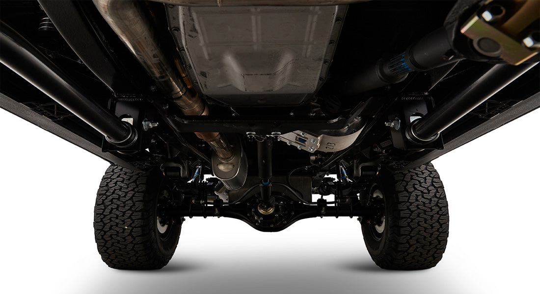 Undercarriage view showing exhaust system, suspension, and tires of Classic Ford Bronco