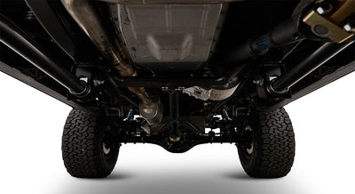 Undercarriage view showing exhaust system, suspension, and tires of Classic Ford Bronco