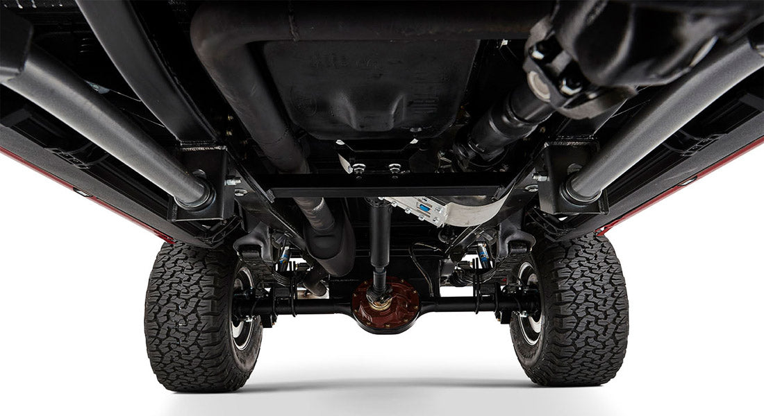 Undercarriage view of classic Ford Bronco showing suspension and dual exhaust