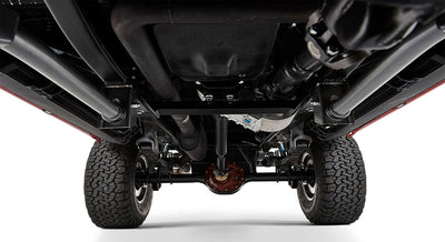 Undercarriage view of classic Ford Bronco showing suspension and dual exhaust