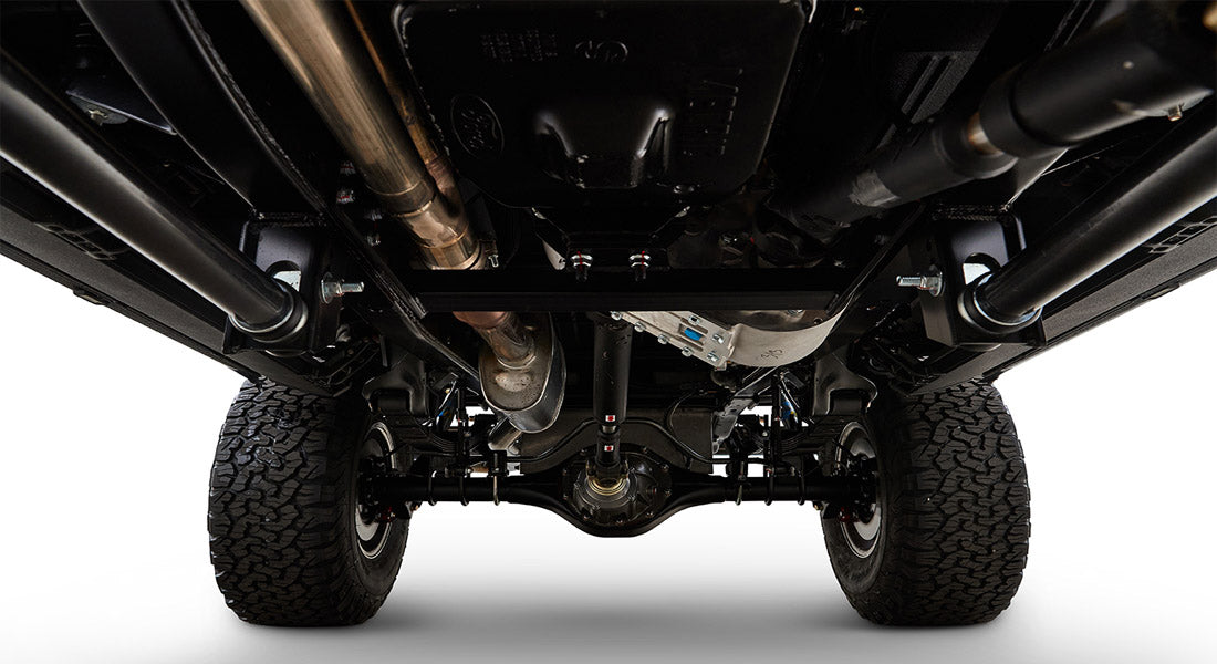 Undercarriage of Classic Ford Bronco showing axles, suspension, and exhaust system