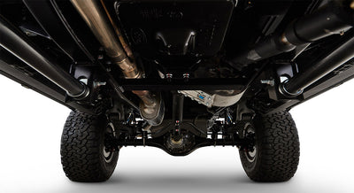 Undercarriage of Classic Ford Bronco showing axles, suspension, and exhaust system