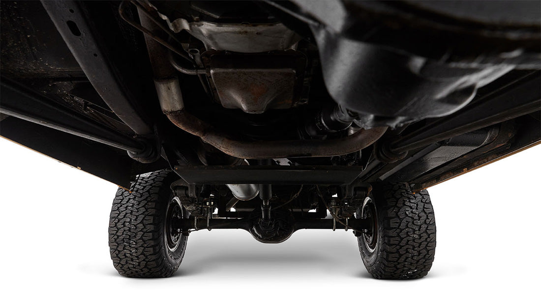Undercarriage view of Classic Ford Bronco highlighting exhaust pipes and suspension