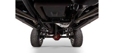 Undercarriage of Classic Ford Bronco showing suspension, drive shaft, and rear axle with tires