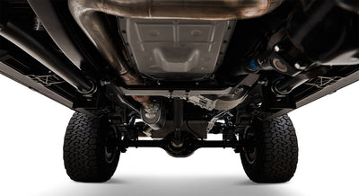 Undercarriage view showing suspension, exhaust, and tires of a Classic Ford Bronco