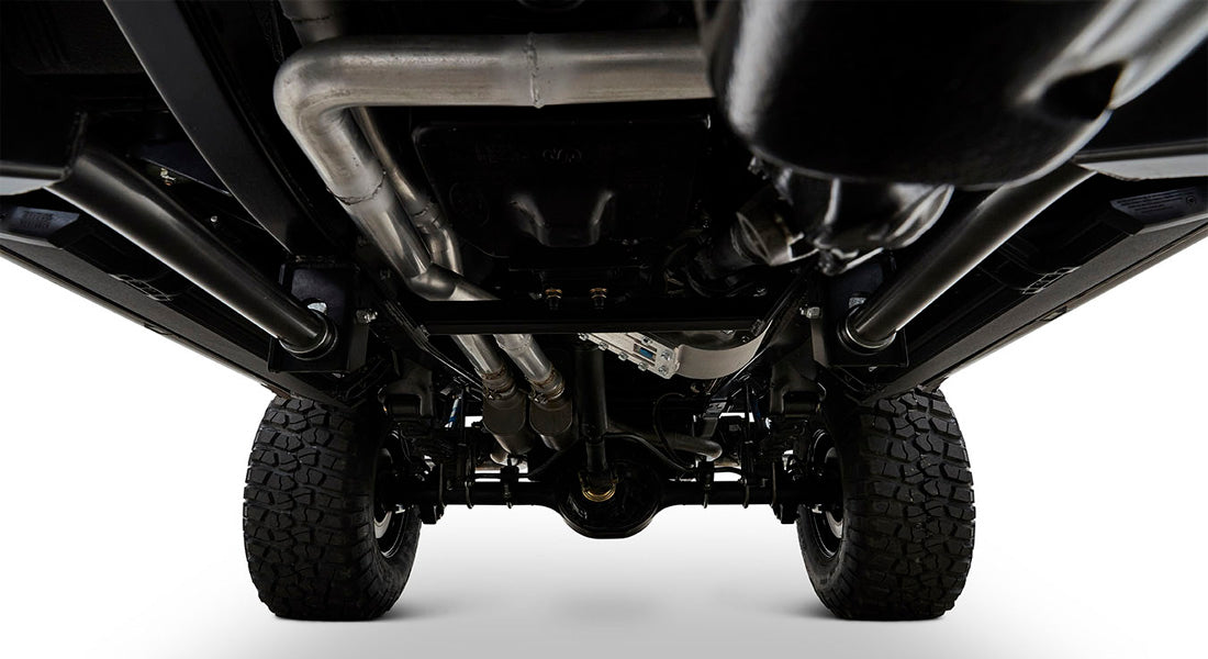 Undercarriage view of Classic Ford Bronco showing tires, exhaust, and chassis components