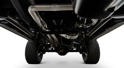 Undercarriage view of Classic Ford Bronco showing tires, exhaust, and chassis components