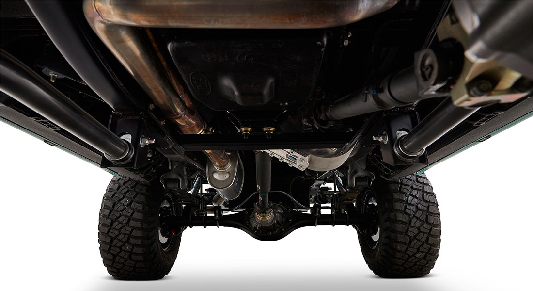 Undercarriage of Classic Ford Bronco showing drivetrain, suspension, and rugged tires