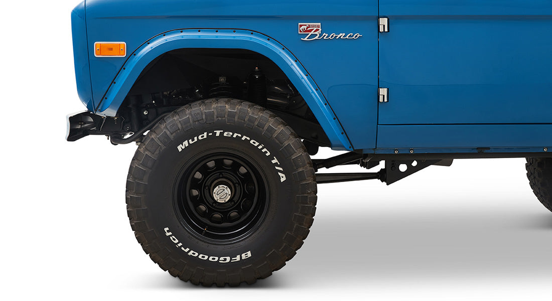 1976 Blue Classic Ford Bronco Coyote Series with black soft top and whiskey leather interior