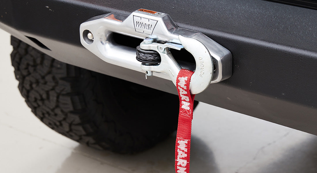 Front bumper with Warn winch and red tow strap on Classic Ford Bronco